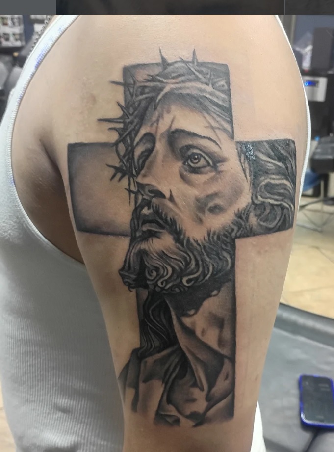 Black and grey crown of thorns and cross tattoo on shoulder
