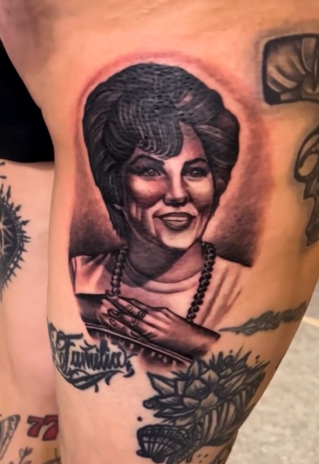 Black and grey memorial portrait tattoo with La Familia script